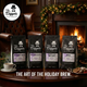 Four bags of 'Mr. Dapper Coffee Roasters' coffee on a table with a fireplace and Christmas decorations in the background.